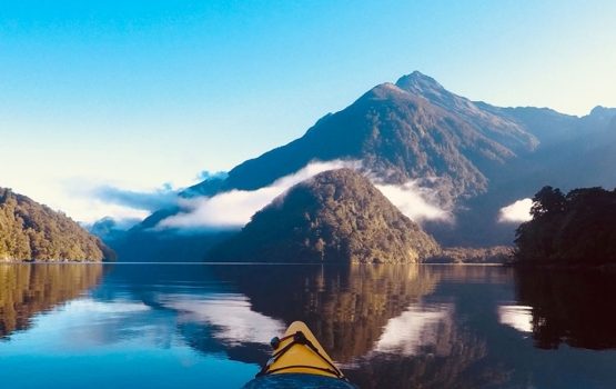Kayak on the ocean with a mountain view